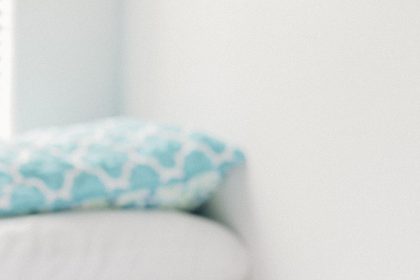 A person sleeps peacefully in a dark, quiet bedroom at night.