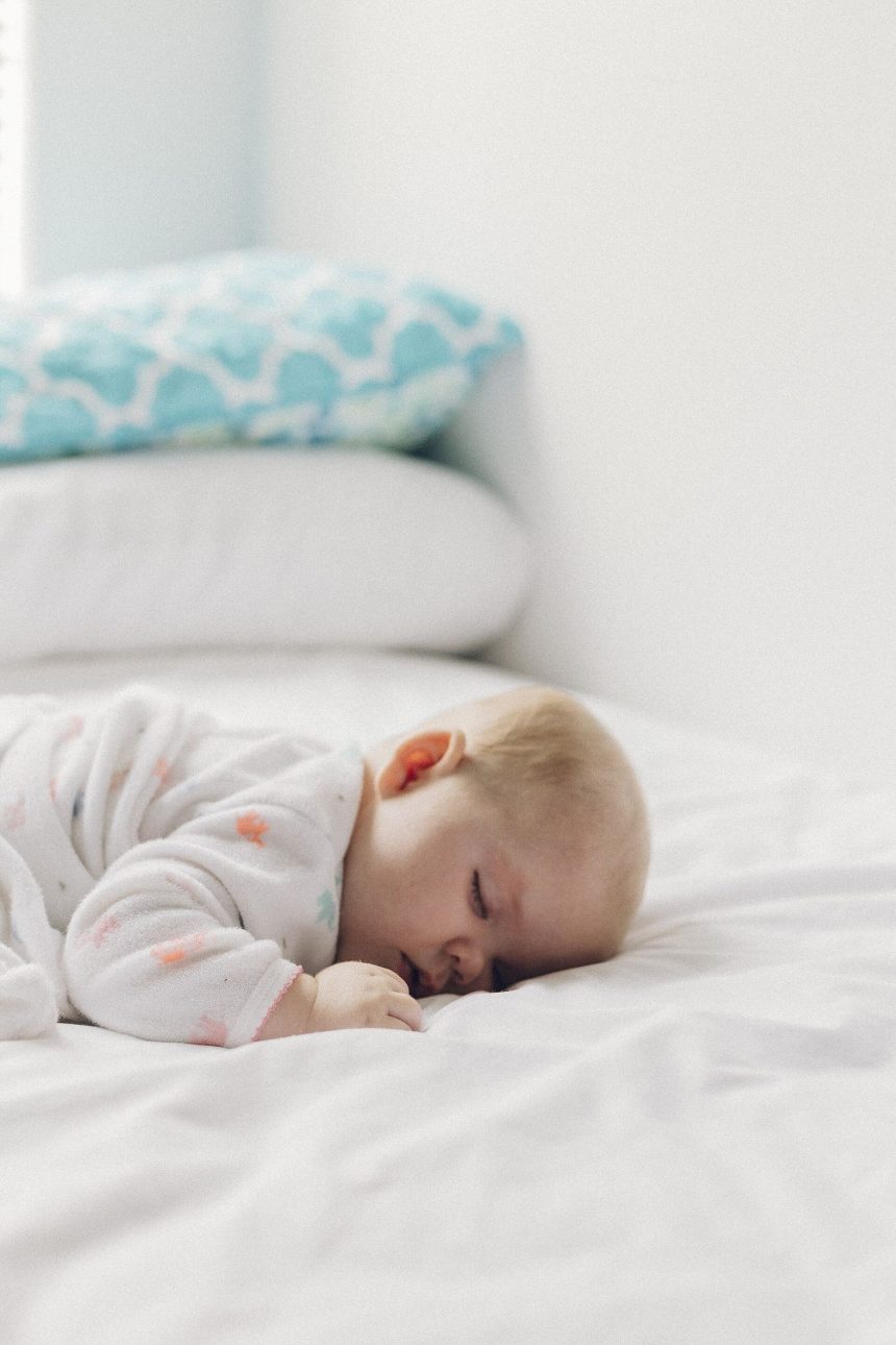 A person sleeps peacefully in a dark, quiet bedroom at night.